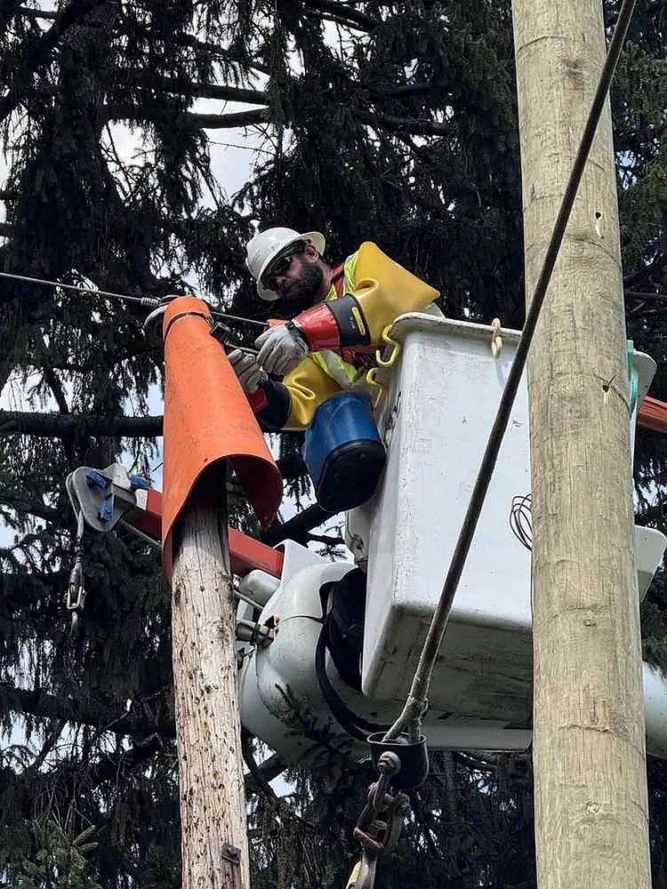 AVO Electric IBEW journeyman performing line construction